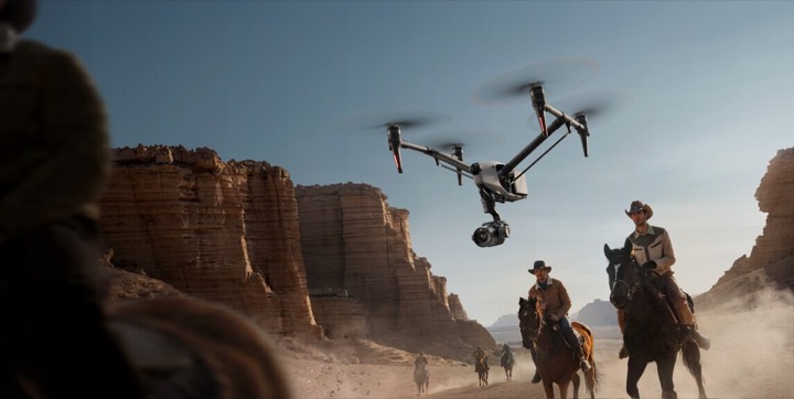 A pilot flying a large camera drone on a job