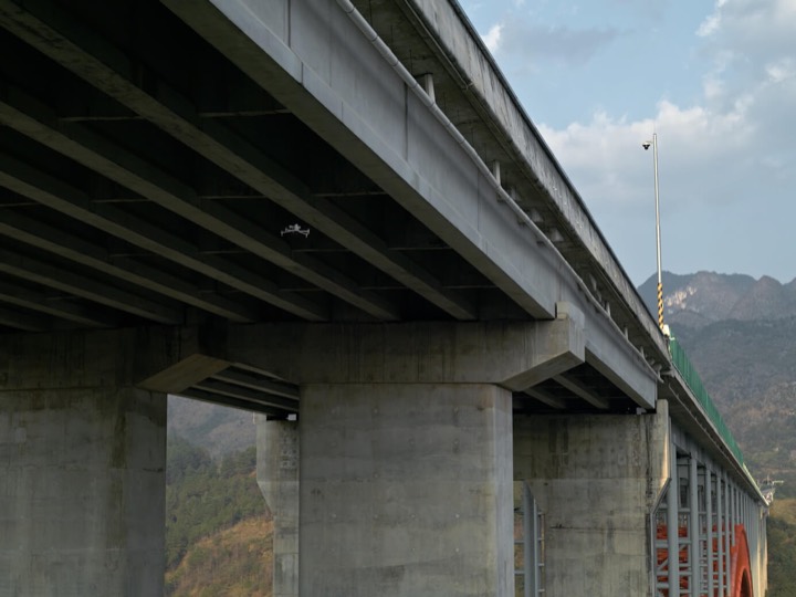 A drone inspecting the underside of a bridge